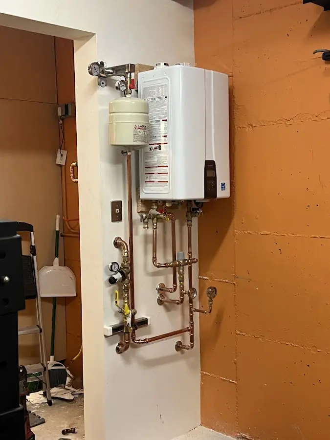 Plumbing technician inspecting water heater connections in Loudoun Valley Estates